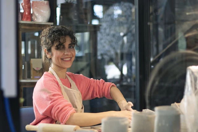 Potter smiling at work in her studio